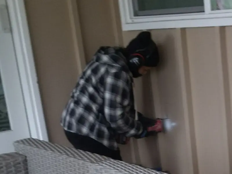 Professional electrician installing an exterior outlet in Henderson